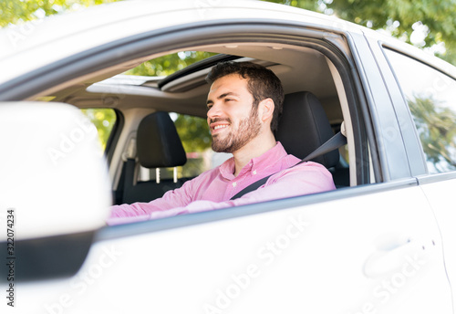 Man Smiling While Driving Car © AntonioDiaz