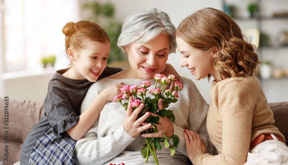 mother's day! three generations of family mother, grandmother and daughter congratulate on the holiday, give flowers . mother's day! three generations of family mother, grandmother and daughter congratulate on the holiday, give flowers .