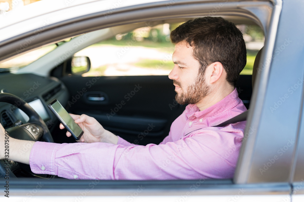 Male Driver Messaging On Mobile Phone In Car Male Driver Messaging On Mobile Phone In Car