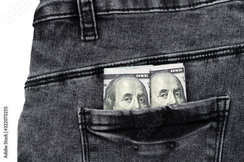 One hundred dollar banknote money in pocket jeans pants background texture. 100 dollar bill close up photo