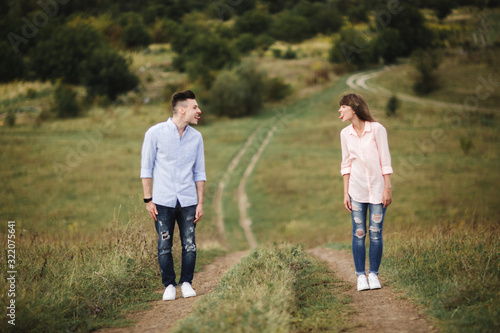 Loving young couple are showing each other the tongue and having fun outdoors. Love and tenderness, dating, romance, family concept. selective focus. © Andriy Medvediuk