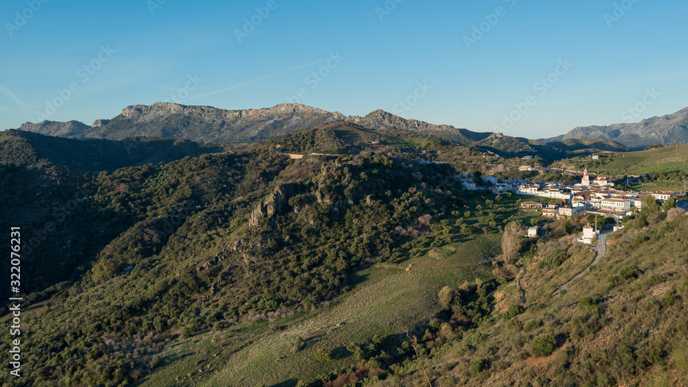 Typical Andalusian white village surrounded by a mountainous landscape. Typical Andalusian white village surrounded by a mountainous landscape.