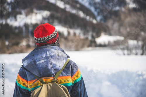 Outdoor adventure: Caucasian girl is taking a walk. Beautiful winter landscape, Austria