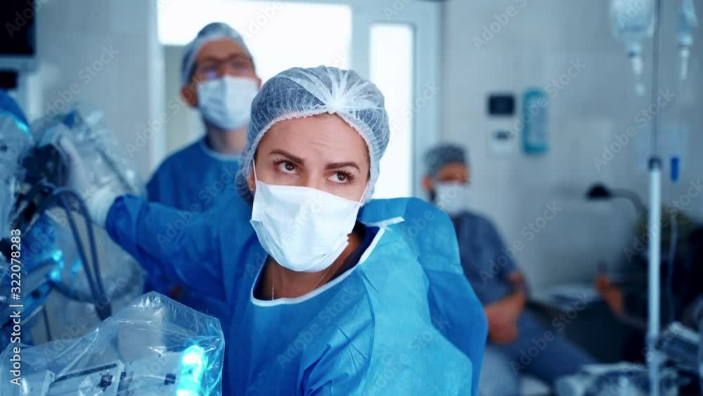 Robot assisted surgical system. Modern equipment in operating room. Team surgeon at work in operating room. Robot assisted surgical system. Modern equipment in operating room. Team surgeon at work in operating room.