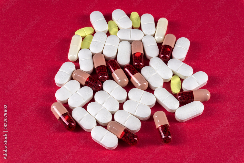 Pills and tablets over pink background Pills and tablets over pink background