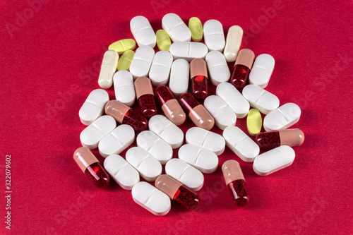 Pills and tablets over pink background 