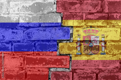 Russia Federation and Spain - National flags on Brick wall. Governments relations and conflict concept.