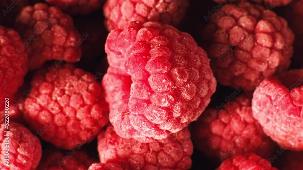 Frozen raspberries with frost rotating, macro shot Frozen raspberries with frost rotating, macro shot