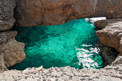 Beautiful cave among the rocks on the coast of the island of Levanzo in Sicily, Italy.