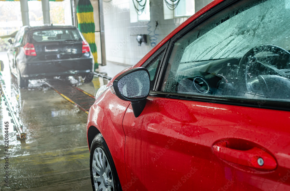 Red car at an automatic car wash. Red car at an automatic car wash.