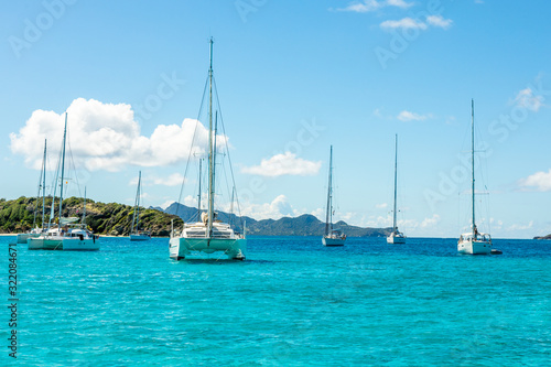 Turquoise colored sea with ancored yachts and catamarans  Tobago Cays tropical islands  Saint Vincent and the Grenadines  Caribbean sea