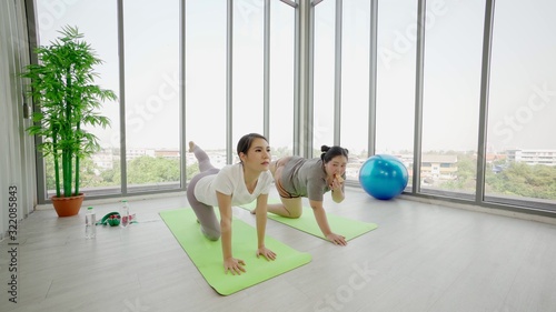 Exercise at home. Asian Slim Girl Teaching a fat woman Exercise to help lose body weight. In your house During the epidemic of coronavirus 