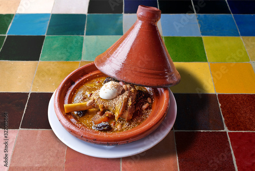 Moroccan Prune lamb tajine on colorful mosaic table