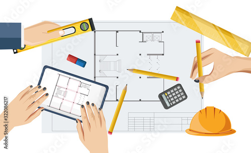 Architect hands drawing a blueprint with rulers, compass and pencil