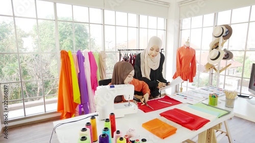 Two Asian Muslim girls Currently working on designing a design within the office.