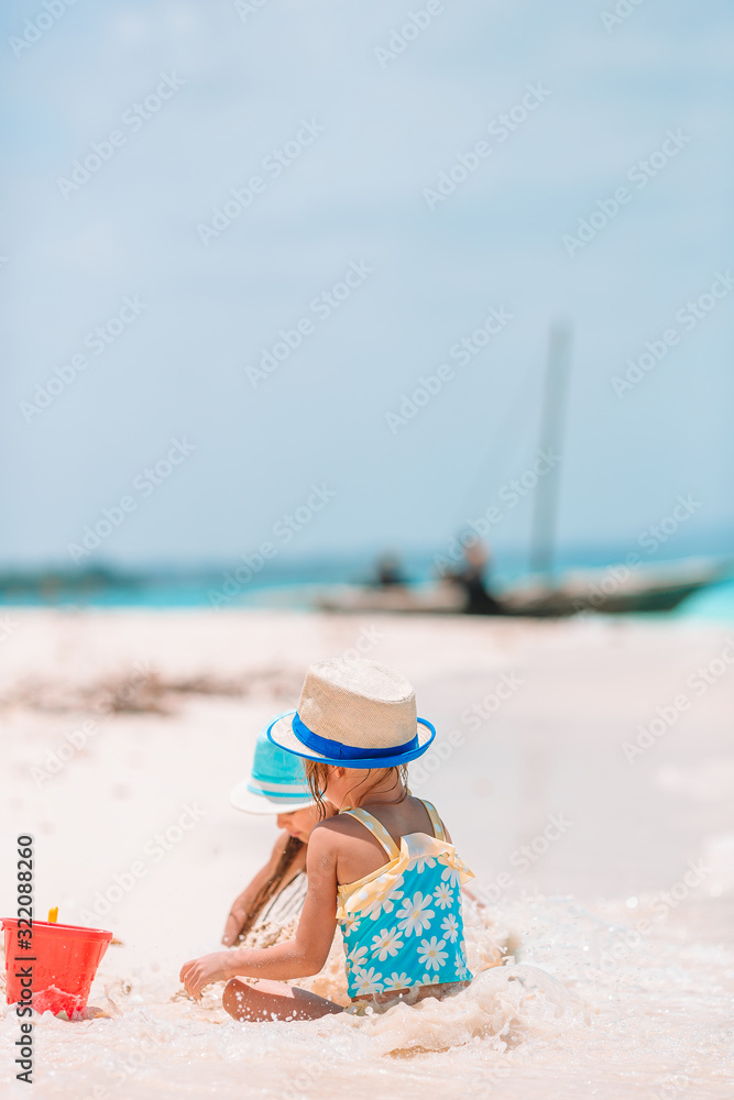 Little girls on the beach during summer vacation