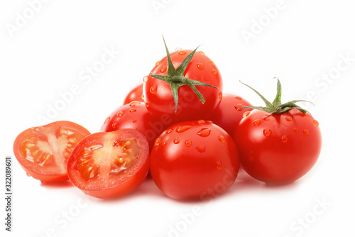 Fresh tomatoes - one sliced - isolated against white