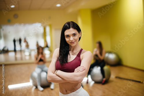 Young beautiful girl posing after group sessions in the gym. Healthy lifestyle © Andrii