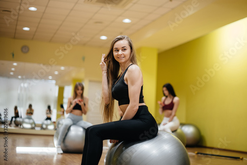 Young beautiful girl posing after group sessions in the gym. Healthy lifestyle