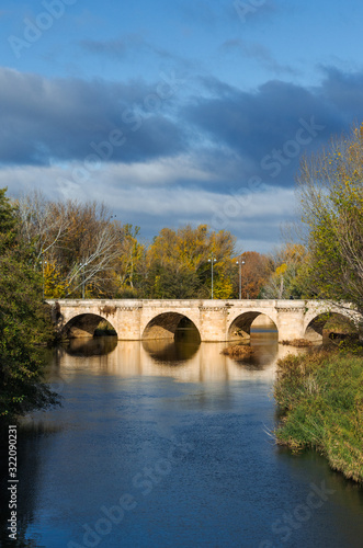 medieval stone bridge, puente mayor, crossing carrion river, palencia, spain © JoseClaudio