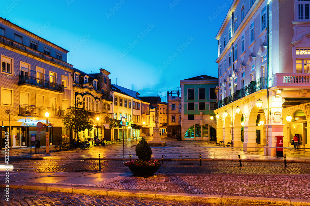 Fototapeta premium View of city center at night with illuminated buildings and dark blue sky in Aveiro, Portugal