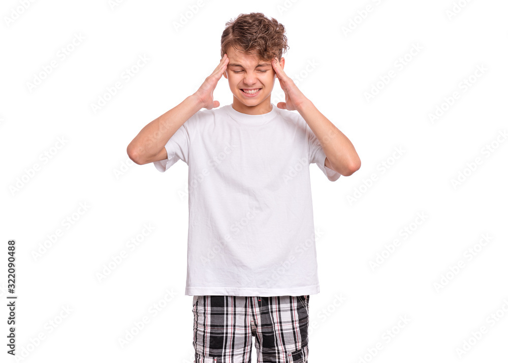 Portrait of teen boy touching his head suffering headache looking tired and sad. Unhappy caucasian young teenager suffering from headache, isolated on white background. Child in white t-shirt. Portrait of teen boy touching his head suffering headache looking tired and sad. Unhappy caucasian young teenager suffering from headache, isolated on white background. Child in white t-shirt.