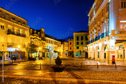 View of city center at night with illuminated buildings and dark blue sky in Aveiro  Portugal