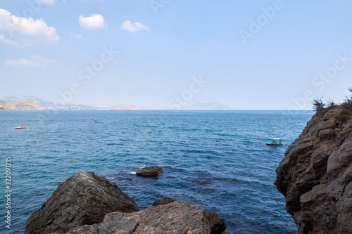Obraz na płótnie View of the Green Bay in the village of New World, coastal cliffs and a ridge of mountains on the horizon. Black Sea coast, Sudak region, Republic of Crimea w salonie
