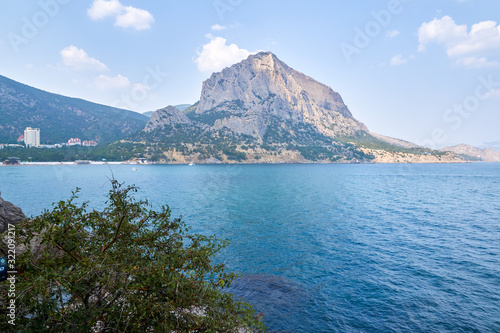 Obraz na płótnie View of the Green Bay in the village of New World, coastal cliffs and a ridge of mountains on the horizon. View of Mount Falcon. Black Sea coast, Sudak region, Republic of Crimea w salonie