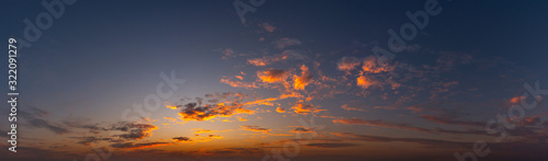 Foto Panorama Sunset with clouds, in orange and colorful shades,World Environment Day concept: Fiery orange sunset sky with dark clouds