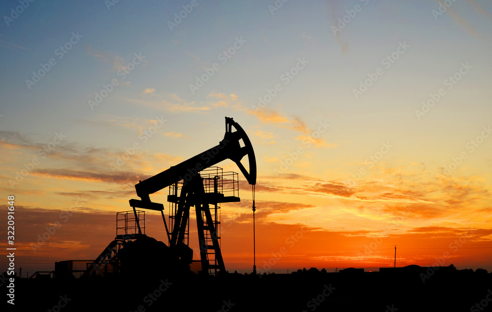 Oil drilling derricks at desert oilfield for fossil fuels output and crude oil production from the ground. Oil drill rig and pump jack. Oil drilling derricks at desert oilfield for fossil fuels output and crude oil production from the ground. Oil drill rig and pump jack.