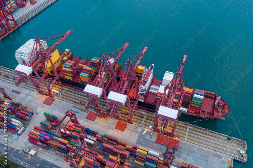 Container terminal, cranes loaded containers on a ships board, view from above