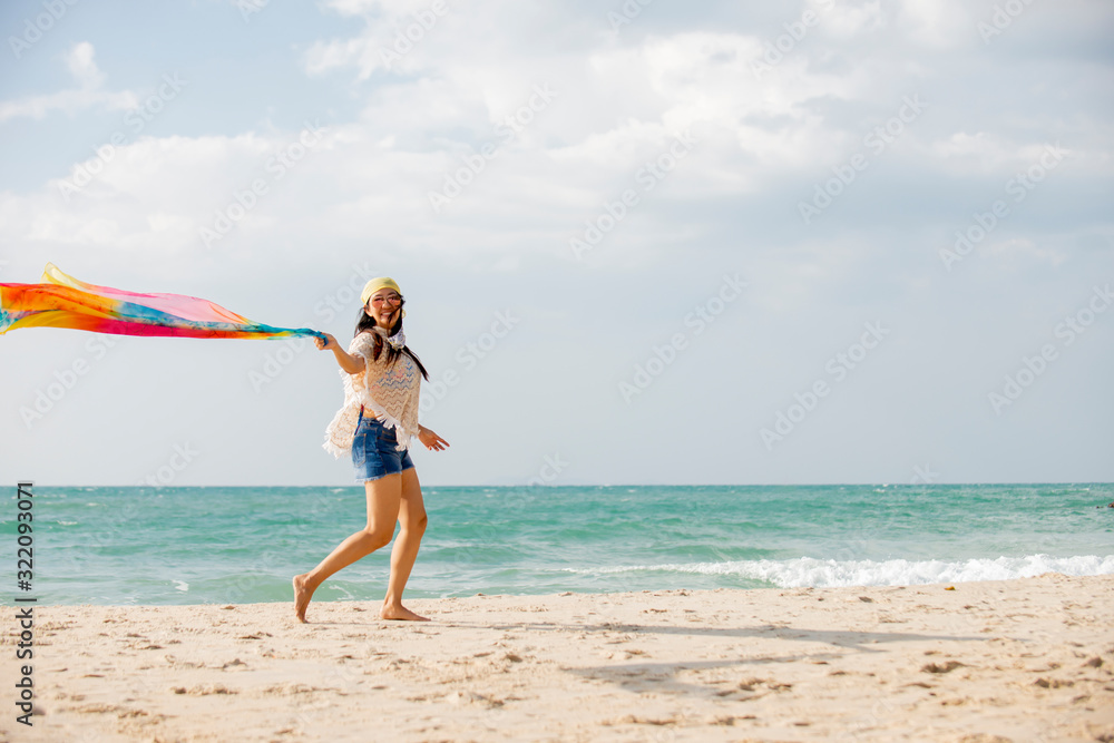 Happy traveler asian woman running on the beach enjoys her tropical vacation Happy traveler asian woman running on the beach enjoys her tropical vacation