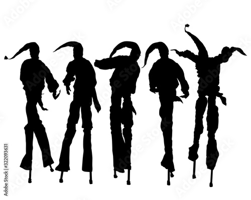 Artist in a clown costume on high stilts. Isolated silhouette on a white background