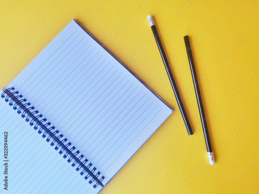 notebook, pen, on yellow background. top view copy space notebook, pen, on yellow background. top view copy space