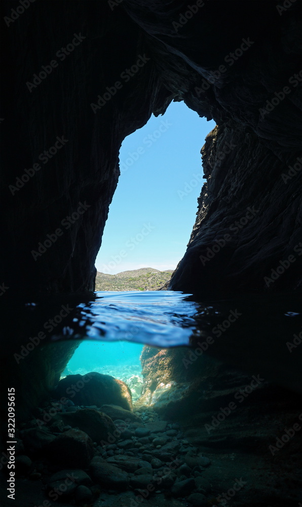 Inside a small cave on the sea shore, split view over and under water surface, Mediterranean sea, Spain, Costa Brava, Catalonia, Cap de Creus, Cadaques, Es Jonquet
