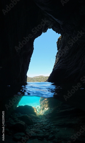 Inside a small cave on the sea shore, split view over and under water surface, Mediterranean sea, Spain, Costa Brava, Catalonia, Cap de Creus, Cadaques, Es Jonquet