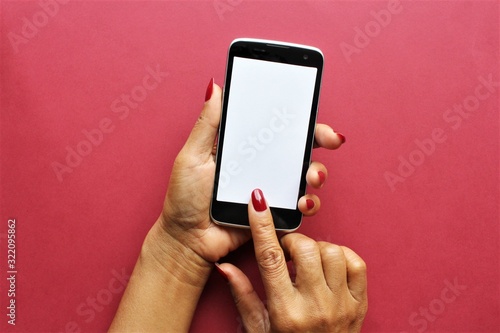 Women hands using smartphone photo isolate on pink background copy space 