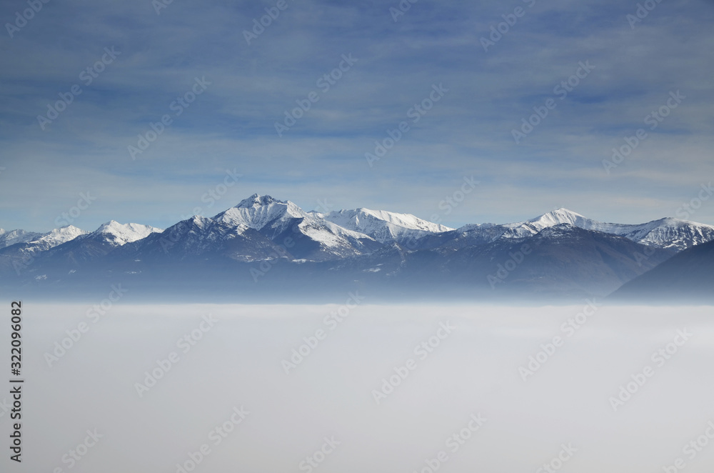 Aerial View over Cloudscape and Snow-capped Mountain in a Sunny Day in Ticino, Switzerland. Aerial View over Cloudscape and Snow-capped Mountain in a Sunny Day in Ticino, Switzerland.