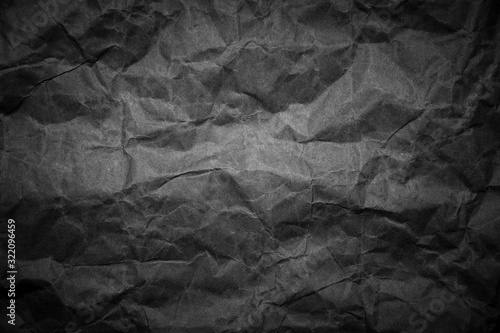 Old black and white crumpled paper grunge texture background.
