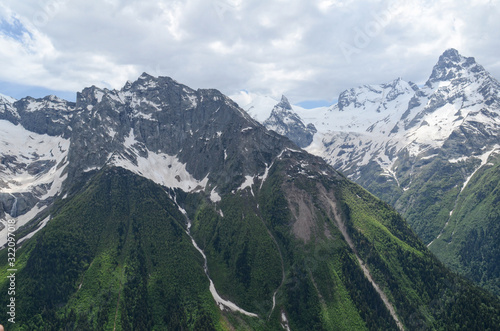 The green valley of Dombay and the snow-capped mountains of the Caucasian ridge