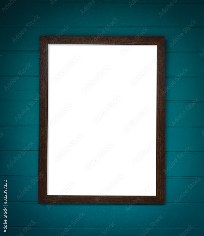 Wooden frame with white color inside hanging on green concrete wall. Wooden frame with white color inside hanging on green concrete wall.