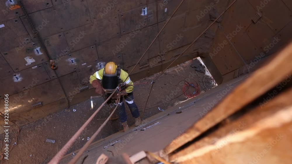 Footage of rope access industrial technician fitters, boilermaker