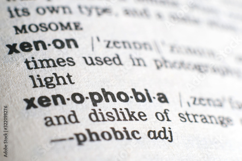 A close-up on a word Xenophobia in English dictionary (selective focus)