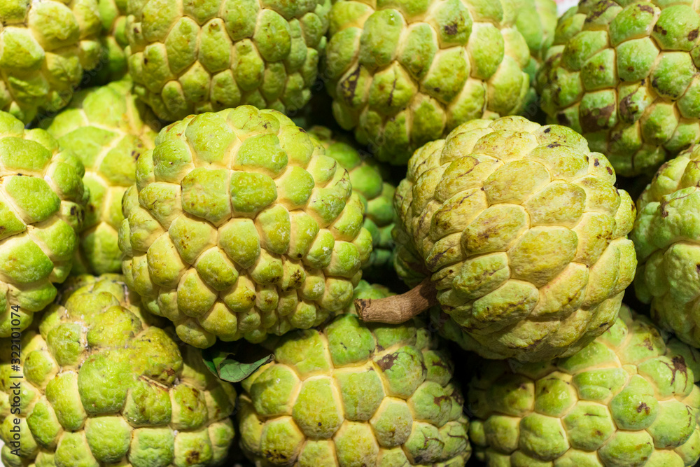 Exotic tropical plant, asian fruit. Cherimoya sweet fruit. Custard fresh apple or sugar apples, Annona. Background. Exotic tropical plant, asian fruit. Cherimoya sweet fruit. Custard fresh apple or sugar apples, Annona. Background.