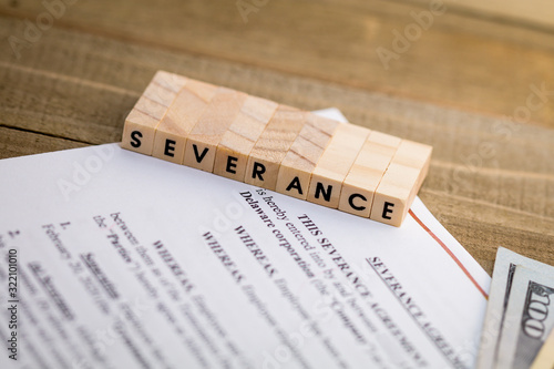 Severance Pay concept with agreement document on wooden board