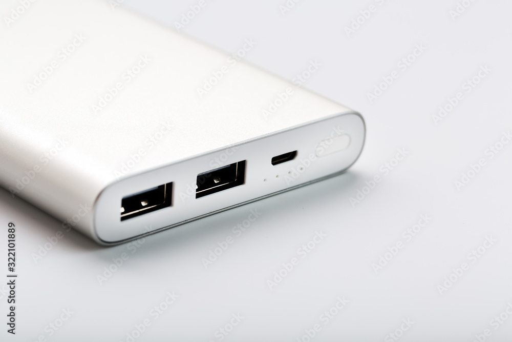 Powerbank for charging mobile devices with cable, on a white background. Powerbank for charging mobile devices with cable, on a white background.