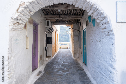 Traditional greek whitewashed buildings, cobblestone streets and stone structure arch. Ioulida village,Tzia, Kea island, Greece. © Rawf8