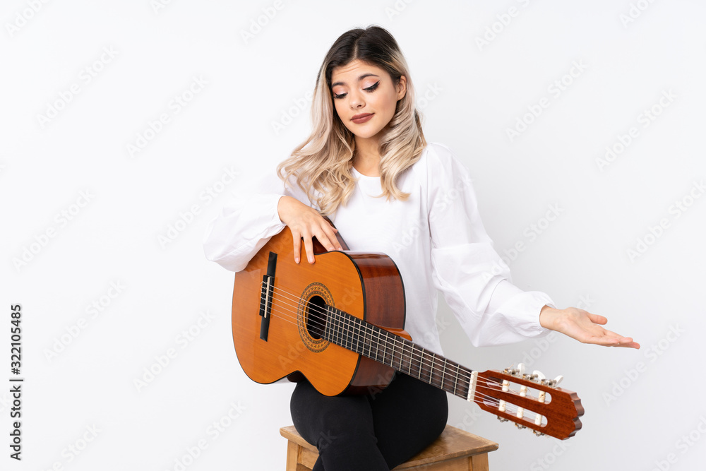Teenager girl with guitar over isolated white background with surprise facial expression Teenager girl with guitar over isolated white background with surprise facial expression