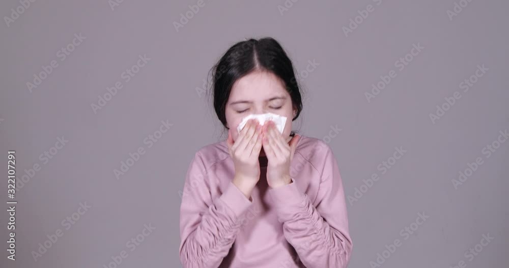 Little girl suffering from cold on grey background Little girl suffering from cold on grey background